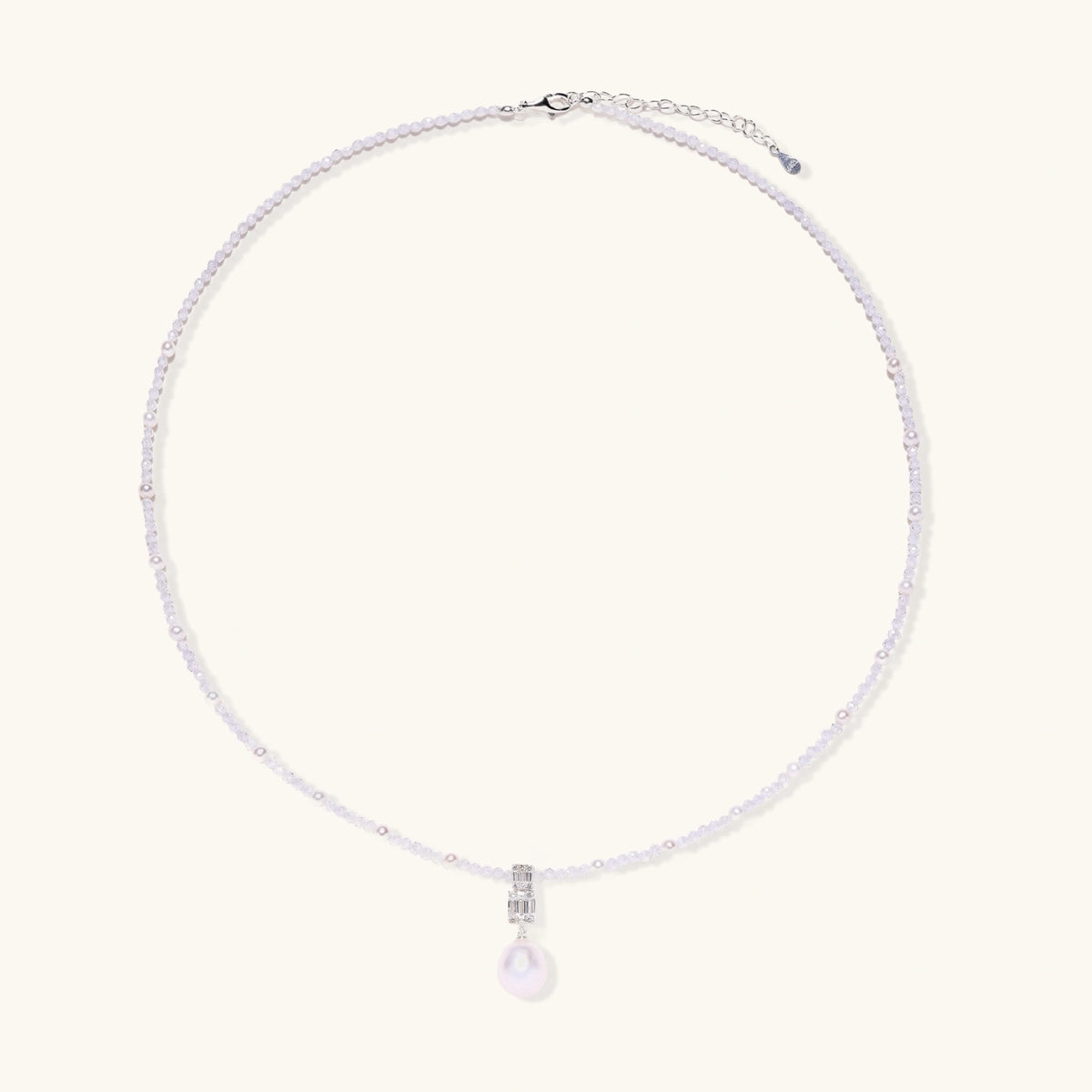 Dainty necklace with lavender crystal beads, freshwater pearls, geometric pendant, and large pearl drop on white background.